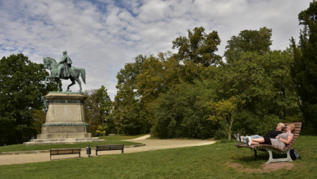 Zwei Frauen liegen auf einer Bank im Hofgarten in Coburg.