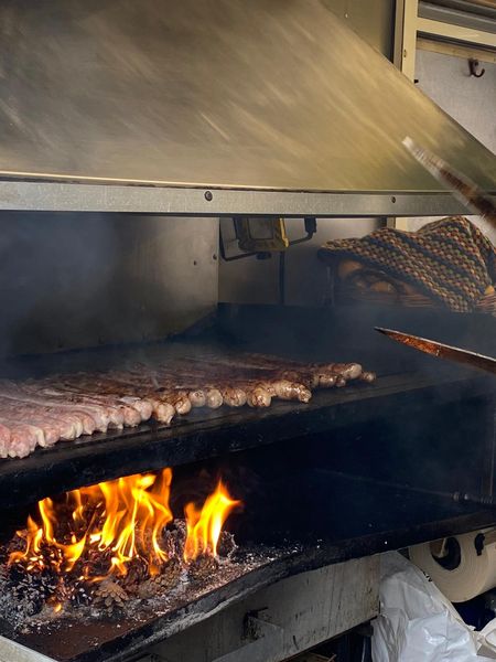 Die Coburger Bratwürste liegen auf dem Grill und werden für das spezielle Aroma auf Kiefernzapfen gebraten.